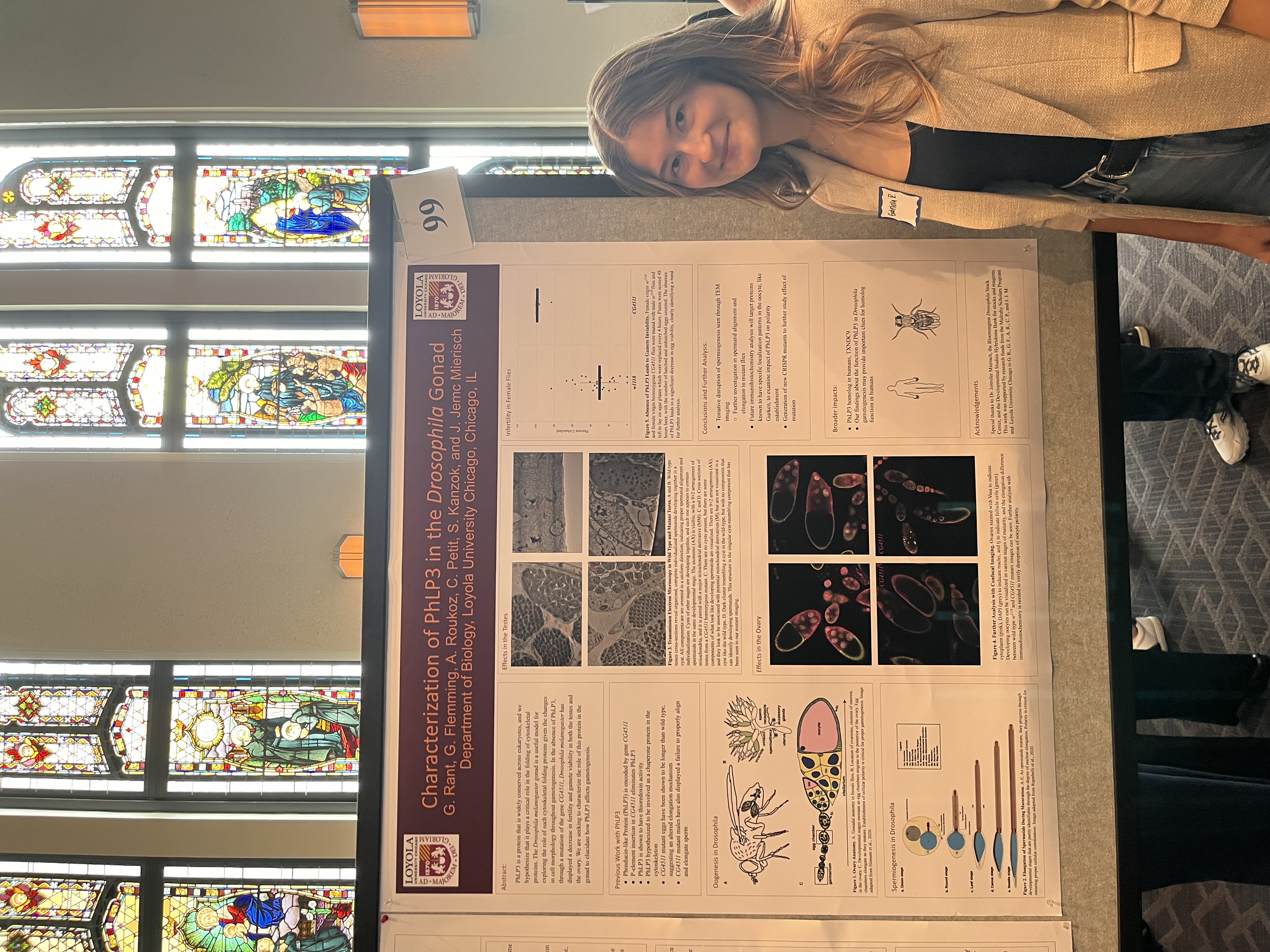Student standing in front of a presentation poster